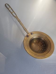 a metal strainer sitting on top of a white counter