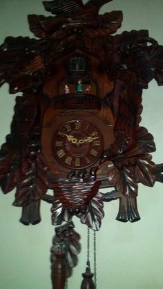 a wooden cuckoo clock hanging on the wall