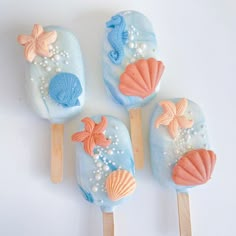 four pops with sea shells and pearls on them