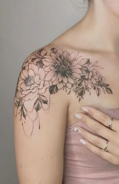 a woman's shoulder with flowers on it