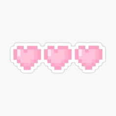 three pink heart shaped stickers sitting on top of each other