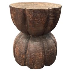 a wooden stool made out of wood with an intricate design on the top and bottom