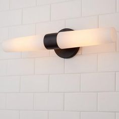 a black and white bathroom light with two lights on the wall next to each other