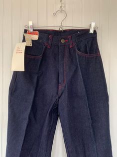 "Rare NWT Vintage Early 80s High Waisted Dark Denim Blue Jeans, by Hush Puppies. New condition and unworn with original tags. Super high rise waist. Front & back pleated down center of leg. Dark denim with red stitching, embroidered back pockets with basset hound logo. Amazing Original condition with original store tags! Brand - Hush Puppies Condition - Original. Deadstock from the 80s, New with original tags 100% Cotton Made in Taiwan Machine Washable Vintage Size - 8 Size - 26\" waist Best Vintage Dark Wash Denim Top With Pockets, Vintage High-waist Dark Wash Pants, Florida Dress, Vintage High-waist Rigid Denim Bottoms, Terry Cloth Dress, Vintage Pre-washed Denim Pants, Vintage Blue Pre-washed Jeans, Jeans High Waisted, Red Jeans