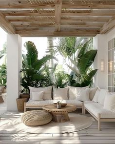 an outdoor living room with white furniture and plants