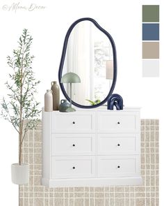 a white dresser topped with a mirror next to a potted plant