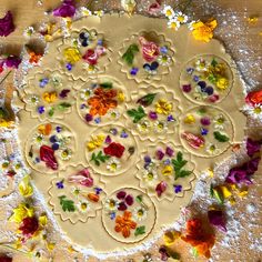 a cookie decorated with flowers and leaves on a table