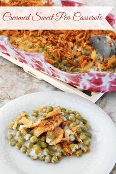 a white plate topped with green beans next to a casserole covered in cheese