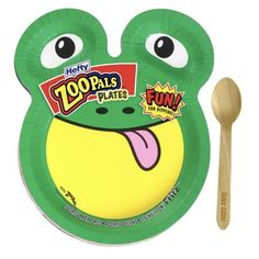 a paper plate with a wooden spoon in front of it and a green frog design on the side