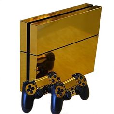 an image of a gold console with two game controllers