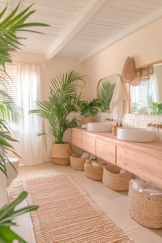 a bathroom with two sinks and large plants in baskets on the floor next to it