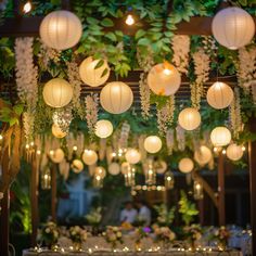 an outdoor wedding with paper lanterns hanging from the ceiling