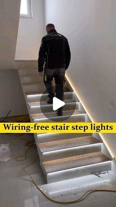 a man is walking up some stairs with his foot in the air and an electric cord attached to it