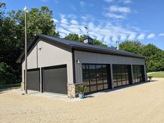 a large garage with two doors on the front and one door open to let in lots of light