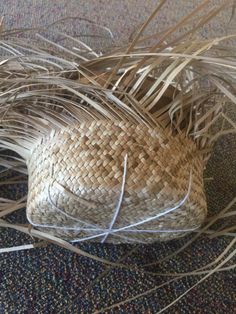 a woven basket sitting on top of a carpet