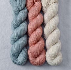 three skeins of yarn in different colors