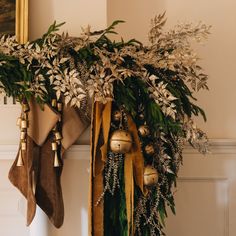 stockings hanging from the mantle with greenery and bells