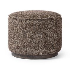 a brown and black ottoman sitting on top of a white floor