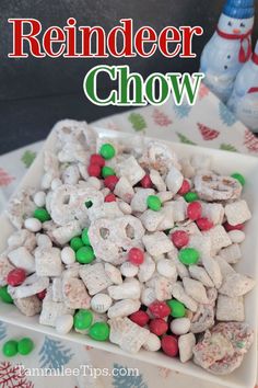 a white bowl filled with christmas candy and marshmallows