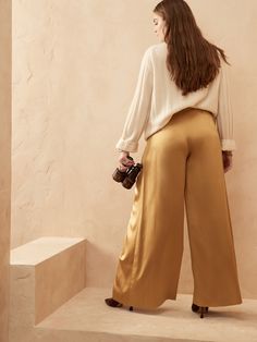 The sensation of silk is here to stay with our soft and satiny charmeuse that is luxurious and easy to care for.  This high waisted pant is light, flowy, and captivating in movement.  Machine washable.  WIDE-LEG FIT: High waisted.  Straight from wais High-waisted Silk Wide Leg Pants For Evening, Silk High-waisted Wide Leg Pants For Evening, Silk High-waisted Wide Leg Evening Pants, High Waist Silk Wide Leg Pants For Work, Elegant Silk Wide Leg Pants With Elastic Waistband, Elegant Wide-leg Silk Pants, Chic High Waist Silk Wide Leg Pants, Chic High-waist Wide Leg Silk Pants, Silk Wide-leg Pants