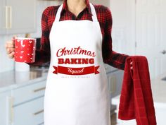 a woman in an apron holding a red mug