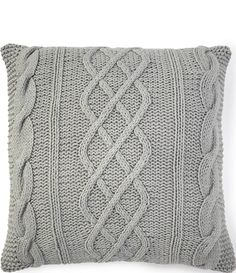 a gray knitted pillow on a white background