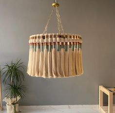 a chandelier hanging from a ceiling in a room with a potted plant