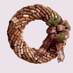 a wreath made out of wine corks with a bow