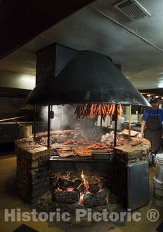 an outdoor grill with lots of food cooking on it