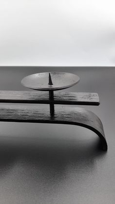 two wooden benches sitting next to each other on top of a gray floored surface