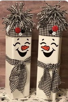 two white boxes with black and white designs on them, each decorated like a clown's face