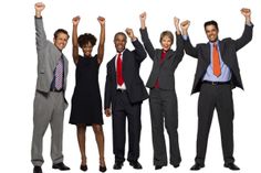 a group of business people raising their hands in the air