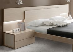 a bed room with a neatly made bed and dressers