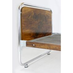 a wooden chair with metal frame and foot rest