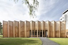 a large wooden building sitting on top of a lush green field