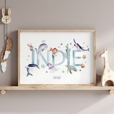 a wooden shelf with an art print on it and two toys hanging from the wall