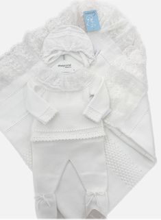 Dress your little one in this adorable White Color 2-piece Knitted Baby Outfit (Top and Pants), crafted from a super soft cotton blend. The set includes a long-sleeved top with a decorative white lace collar and back button closure, along with matching footed pants adorned with a white decorative bow on the front. Pair it with the cozy bonnet and matching blanket, sold separately. Made in Spain 50% cotton, 50% acrylic (soft knit) Machine washable in warm water Set includes top and pants If in between sizes, we recommend sizing up White Loungewear Sets For Winter, White Winter Loungewear Sets, White Knitted Long Sleeve Set, Knitted Cotton Sets For Winter, Knitted Cotton Winter Sets, Winter Knitted Cotton Sets, Cream Cotton Sets For Baptism, White Cotton Sets For Baptism, White Cotton Baptism Sets