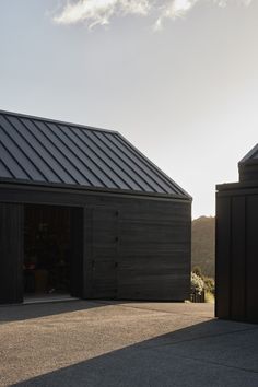 two black garages side by side with one door open