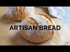 two loaves of bread sitting on top of a cutting board with the words artisan bread