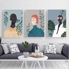 three paintings hang on the wall above a couch in a living room with a coffee table