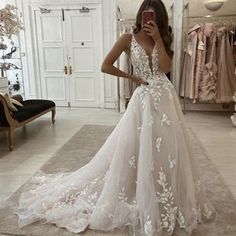 a woman is taking a selfie in her wedding dress while looking into the mirror