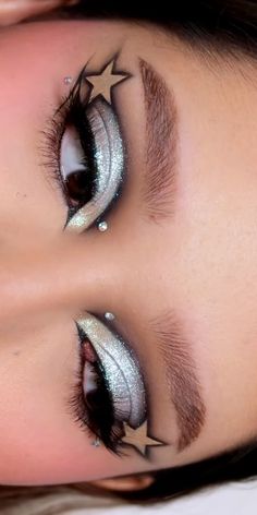 silver star makeup with gems Star Themed Makeup Look, Star Over Eye Makeup, Celestial Eye Makeup, Eyeliner Looks Colorful, Red Star Makeup, Rockstar Eye Makeup, Coraline Makeup Looks, Black Star Makeup, Pop Of Color Eye Makeup