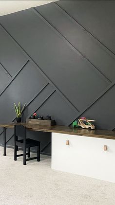 a room with two desks and some toys on top of the table in front of it