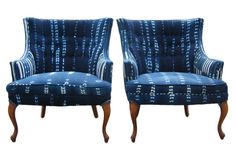 a pair of blue upholstered chairs