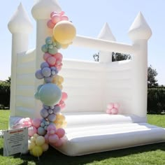 an inflatable arch is decorated with balloons