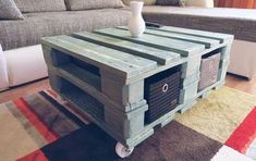 a coffee table made out of pallet wood with baskets on the bottom and wheels