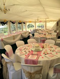 tables and chairs are set up in a tent for a wedding or other function,