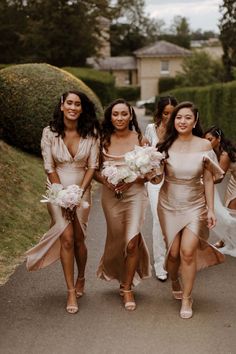 the bridesmaids are walking down the road together