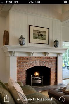 a living room filled with furniture and a fire place next to a couch in front of a fireplace