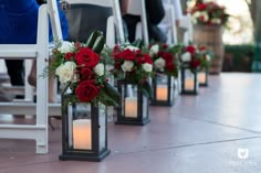 red and white flowers are placed in small vases on the floor next to each other